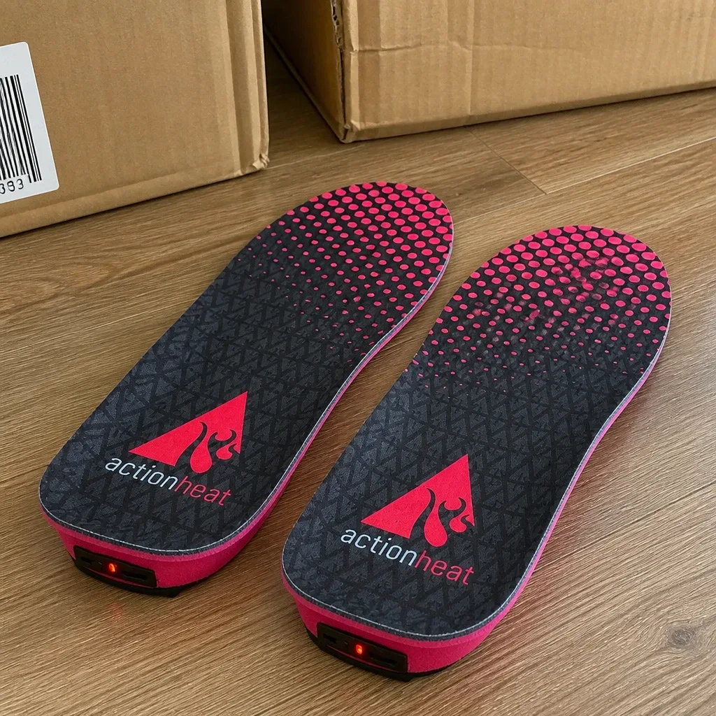 ActionHeat heated insole boxes on the floor next to the insoles and remote
