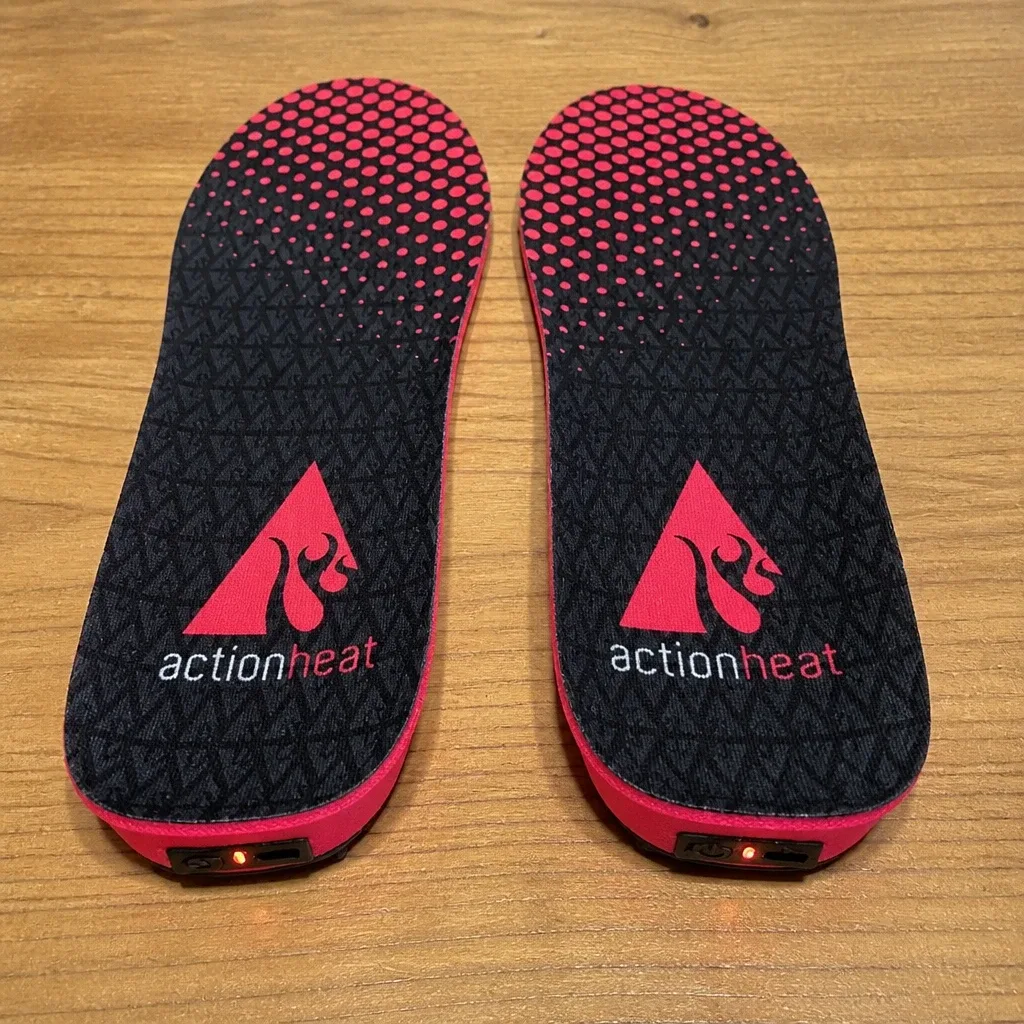 A single ActionHeat heated insole on a kitchen table showing the cut-to-fit toe outline