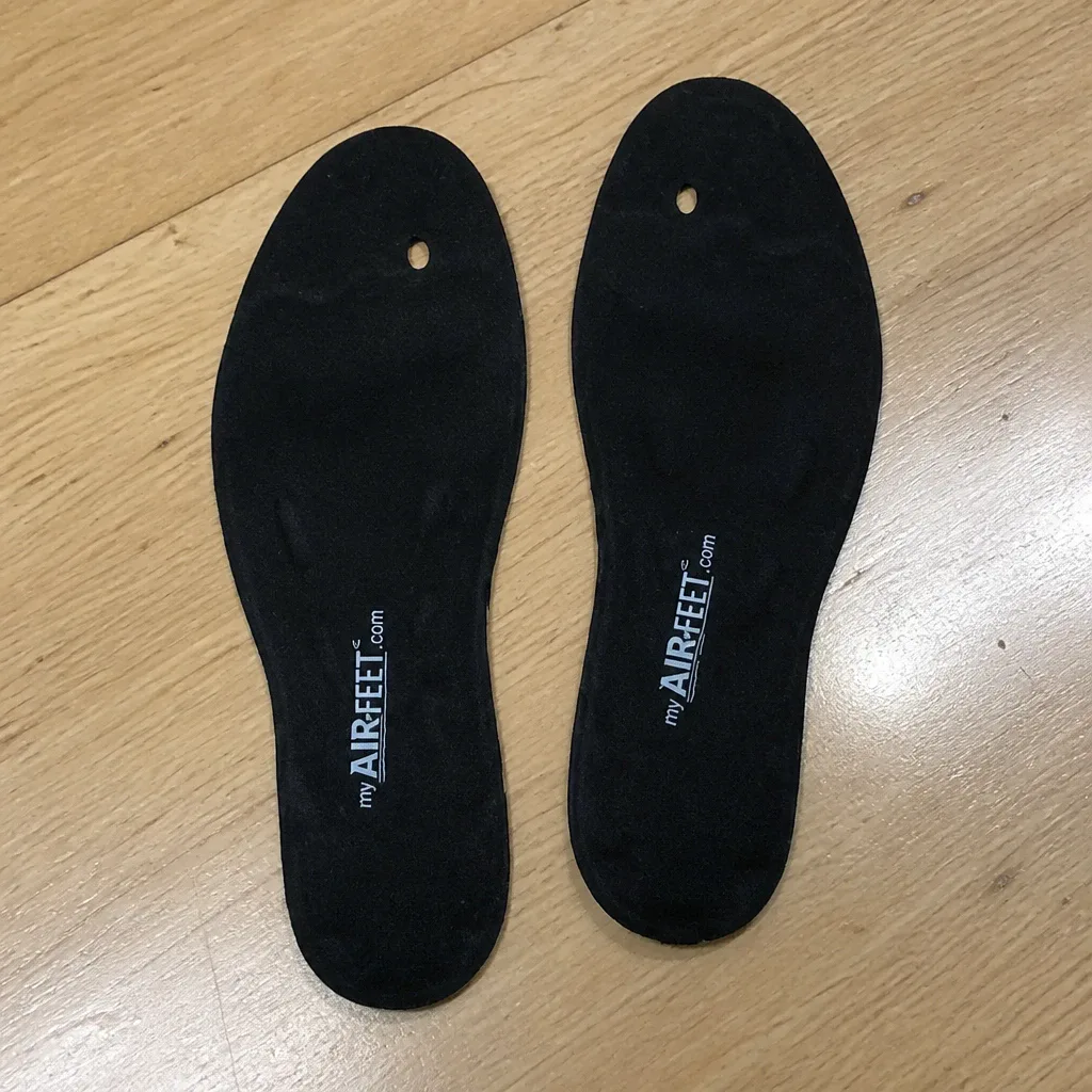 A pair of AirFeet Classic O2 insoles laid flat on a kitchen table after washing