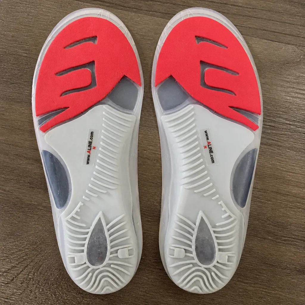 A pair of Aline insoles on a kitchen table with pricing and packaging visible