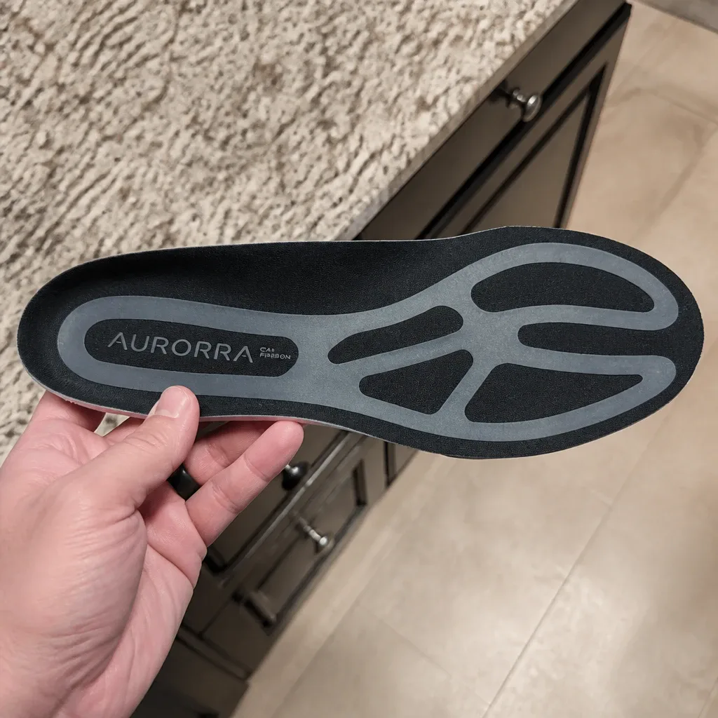 A hand holding an Aurorra by ARRIS Super Insole