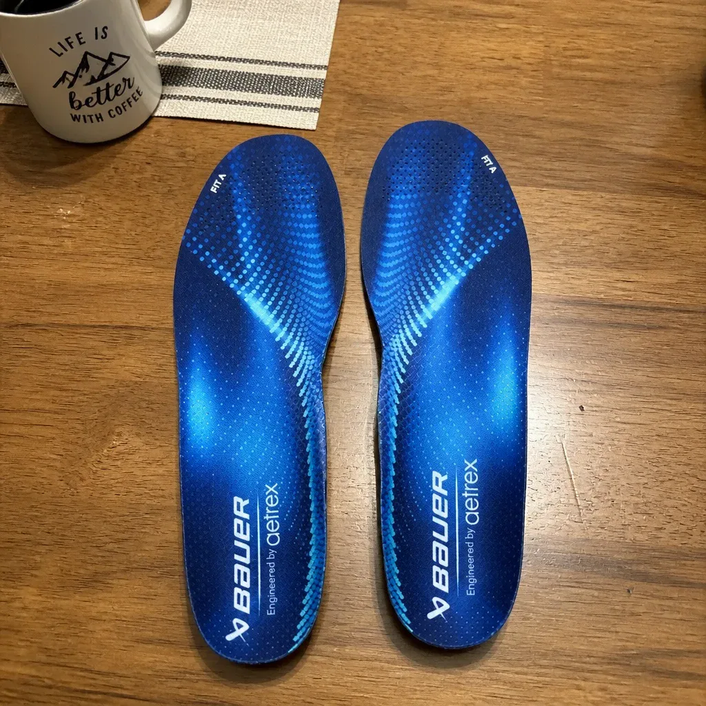 A pair of Bauer Aetrex Fit A skate orthotics on a kitchen table