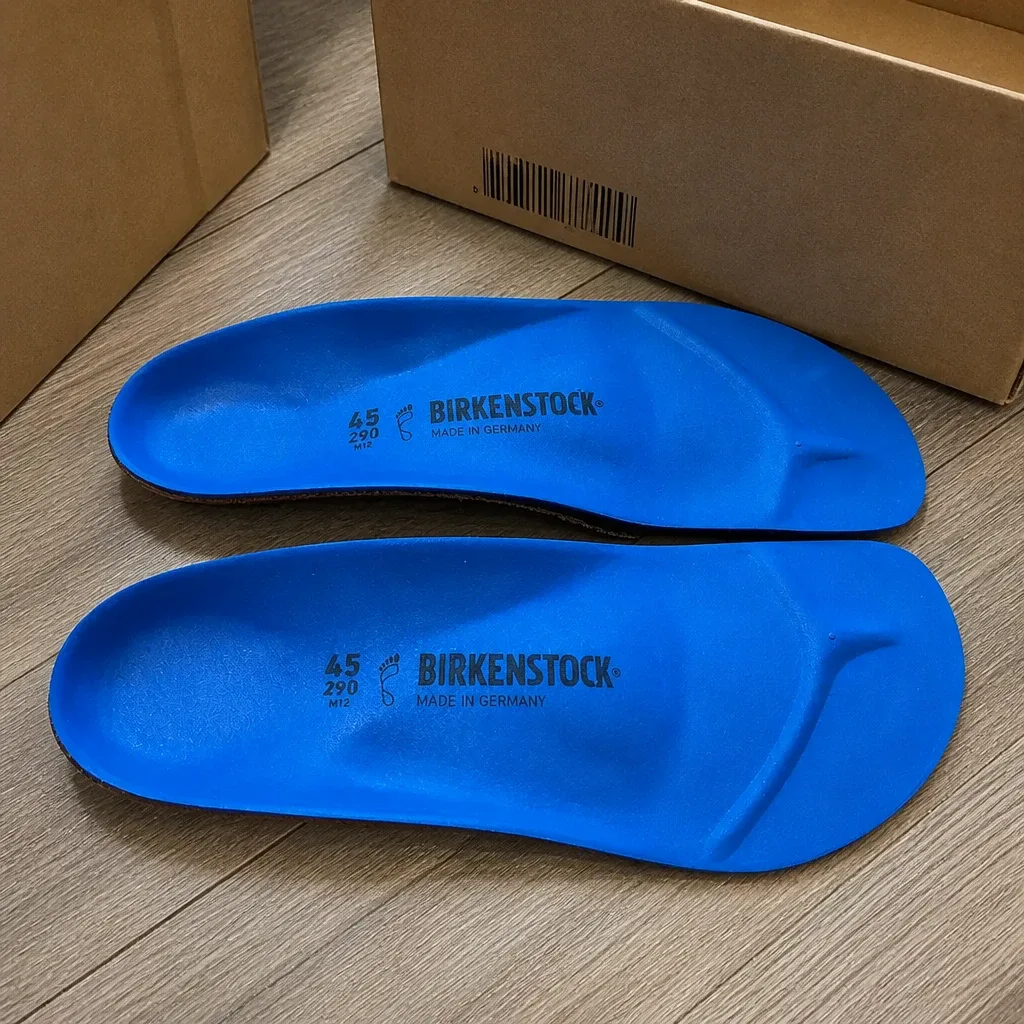 Birkenstock Birko Sport insoles laid out beside their retail boxes