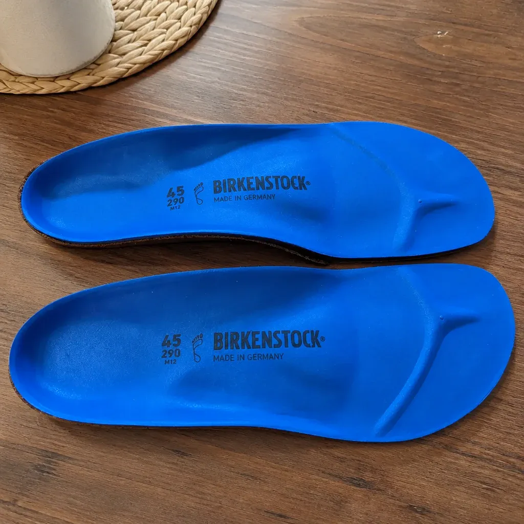Birkenstock Birko Sport insoles laid flat on a kitchen table, showing the cork base and foam top-cushion