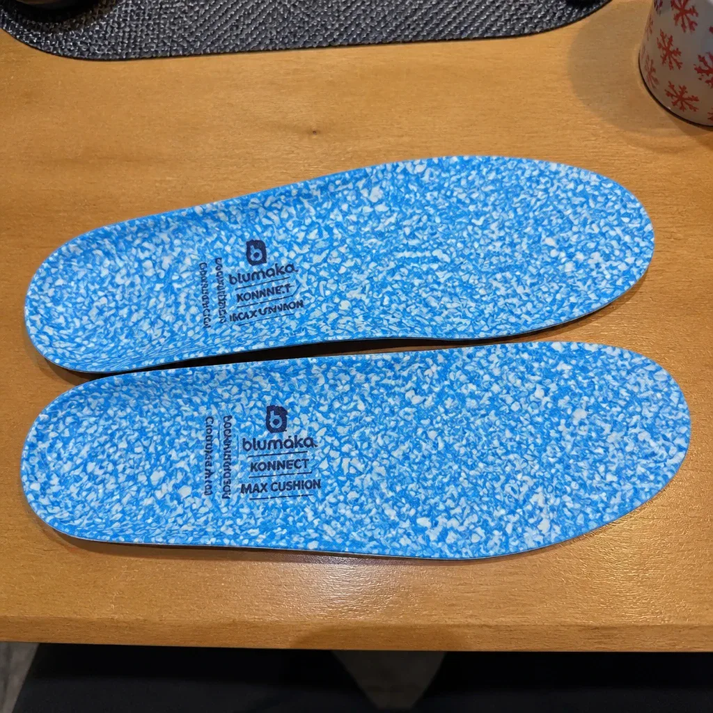 Blumaka NonSlip Performance Insoles laid flat on a kitchen table, showing the top cover and foam base