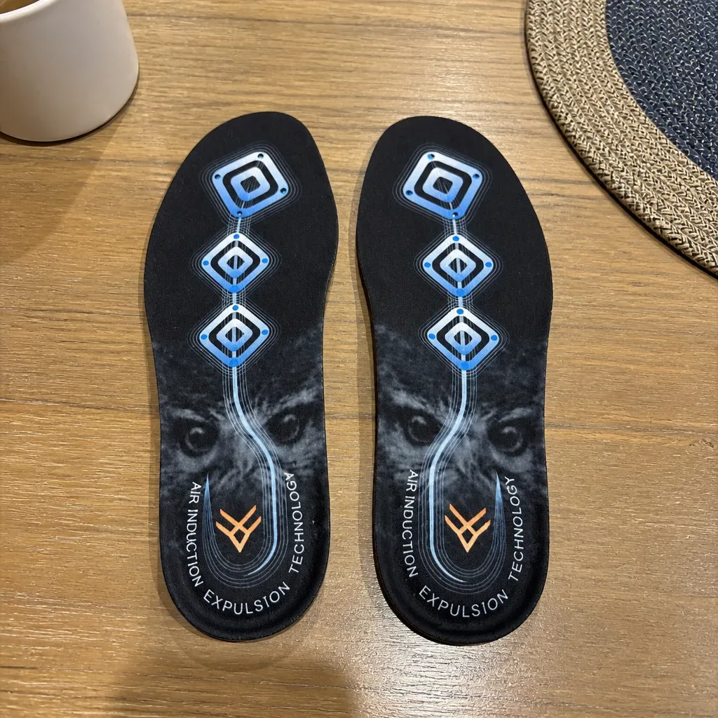 A pair of Hawx Ground Support Work Boot Insoles laid flat on a kitchen table for a checked-pair comparison