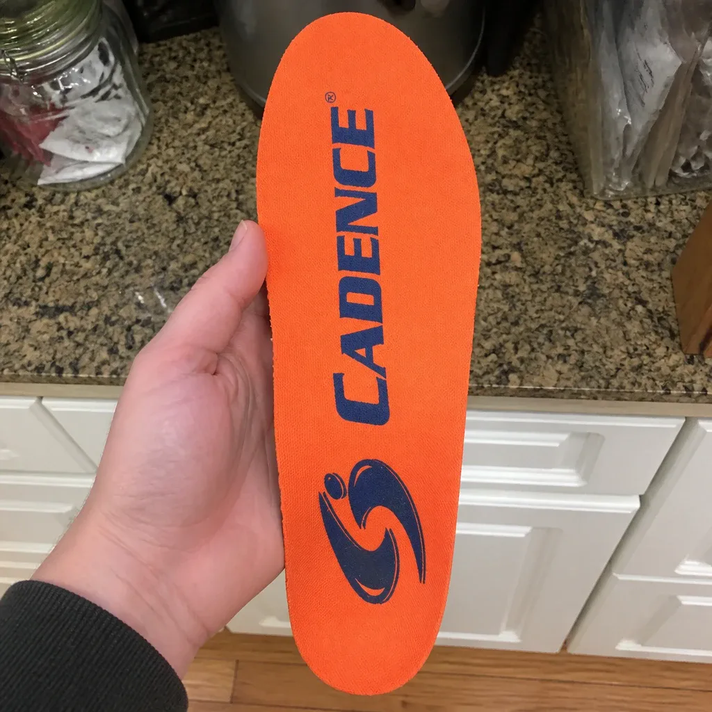 Cadence Original Orange Insole held in hand to check shell flex
