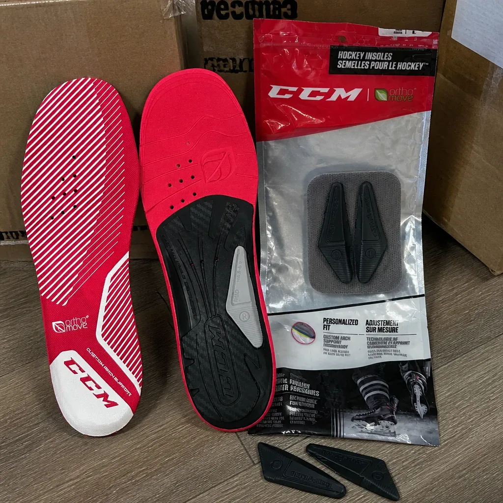CCM Orthomove hockey skate insoles unboxed next to their retail packaging