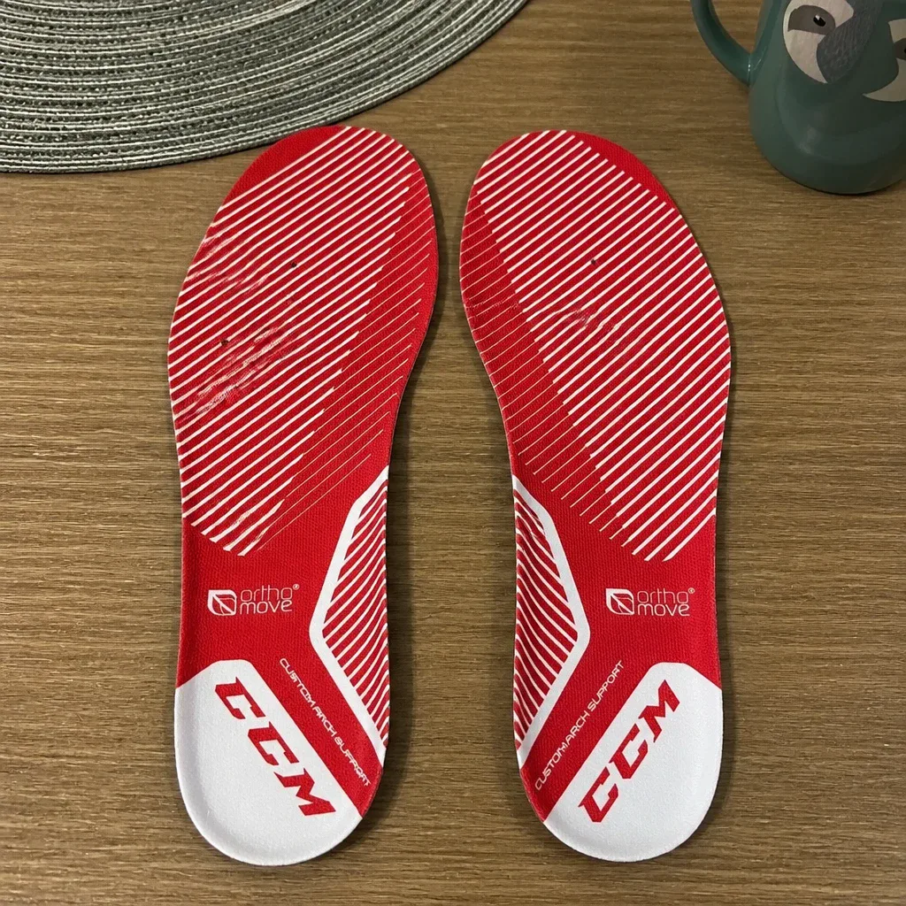 CCM Orthomove hockey skate insoles laid out on a kitchen table