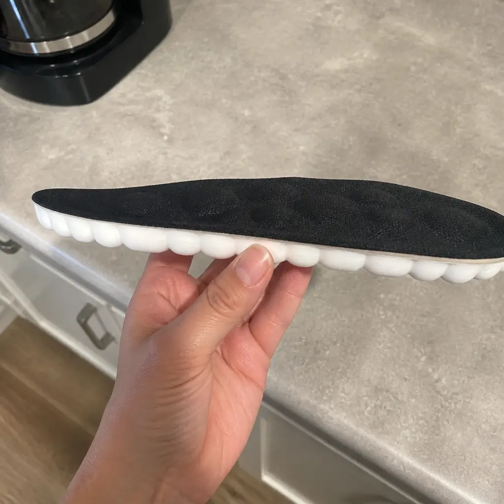 CloudSole Insoles viewed from the side, held in hand
