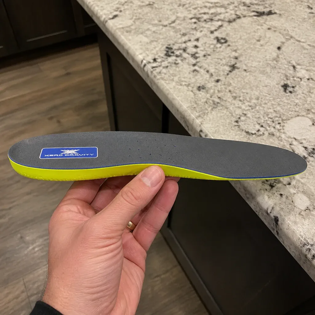 Side view of a Cody James Xero Gravity Comfort Insole held by hand