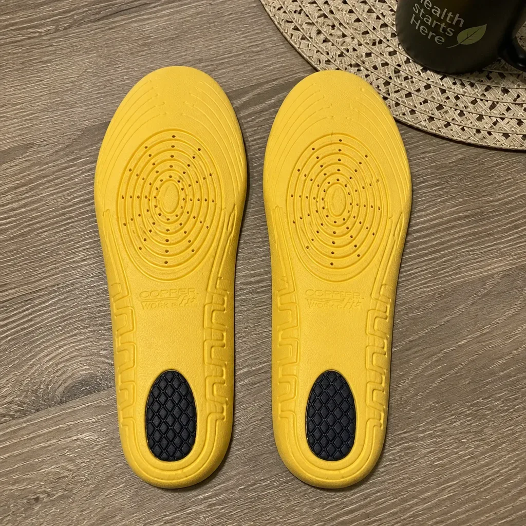 A pair of Copper Fit Work Gear Comfort Insoles on a kitchen table with packaging visible