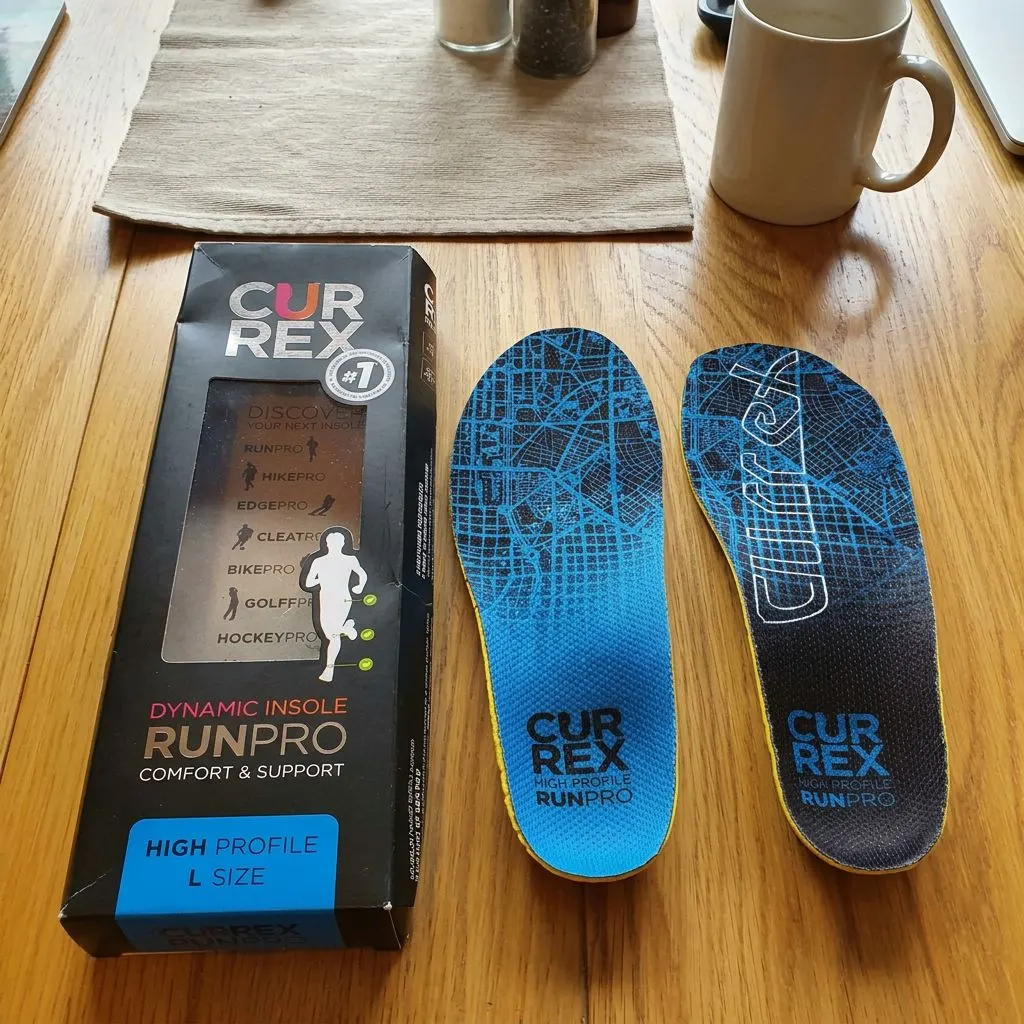 The CURREX RunPro retail box shown next to a pair of RunPro insoles, with the brand's activity-specific lineup printed on the box