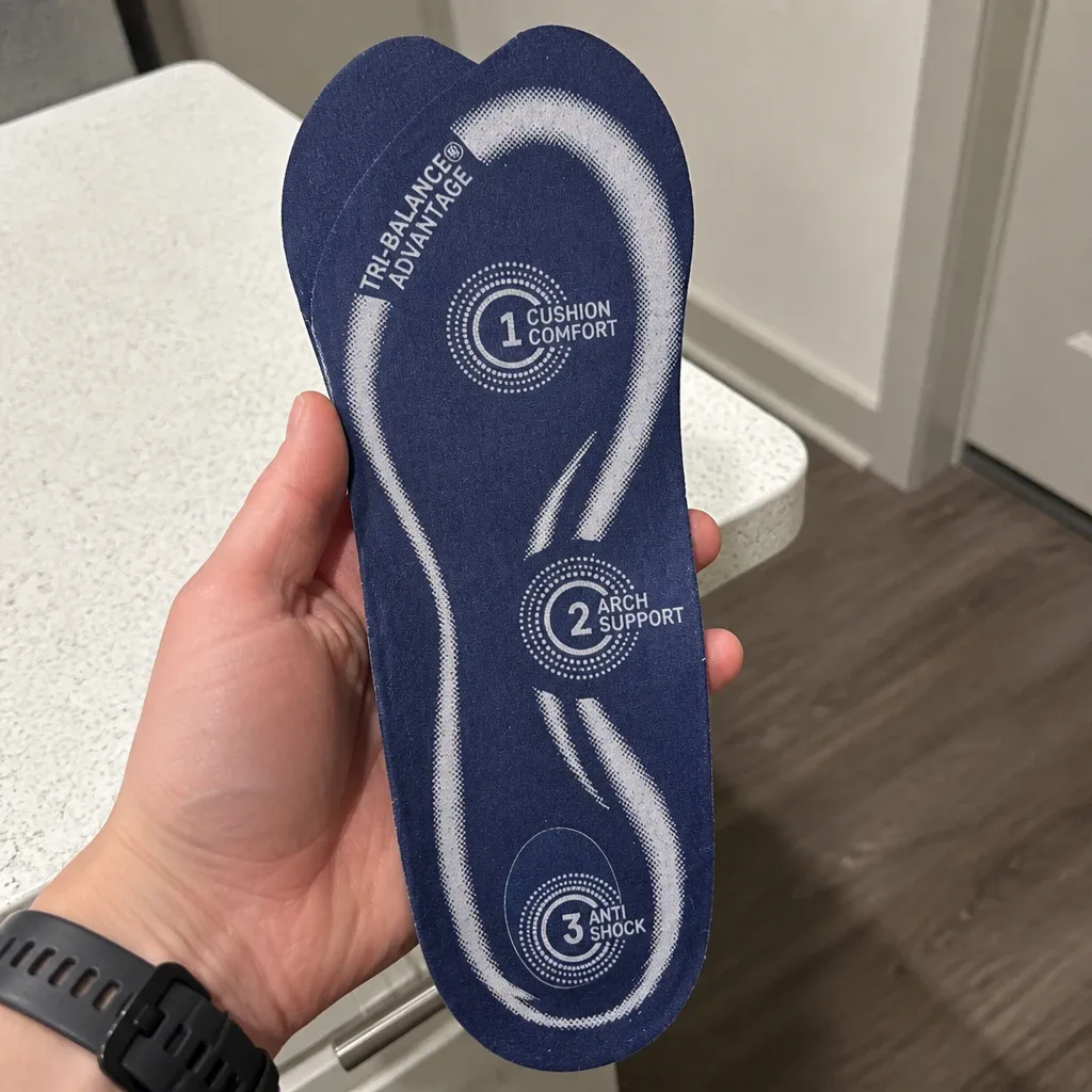 Holding a CVS Health Advanced Gel Orthodics insole to show the gel heel and forefoot pads