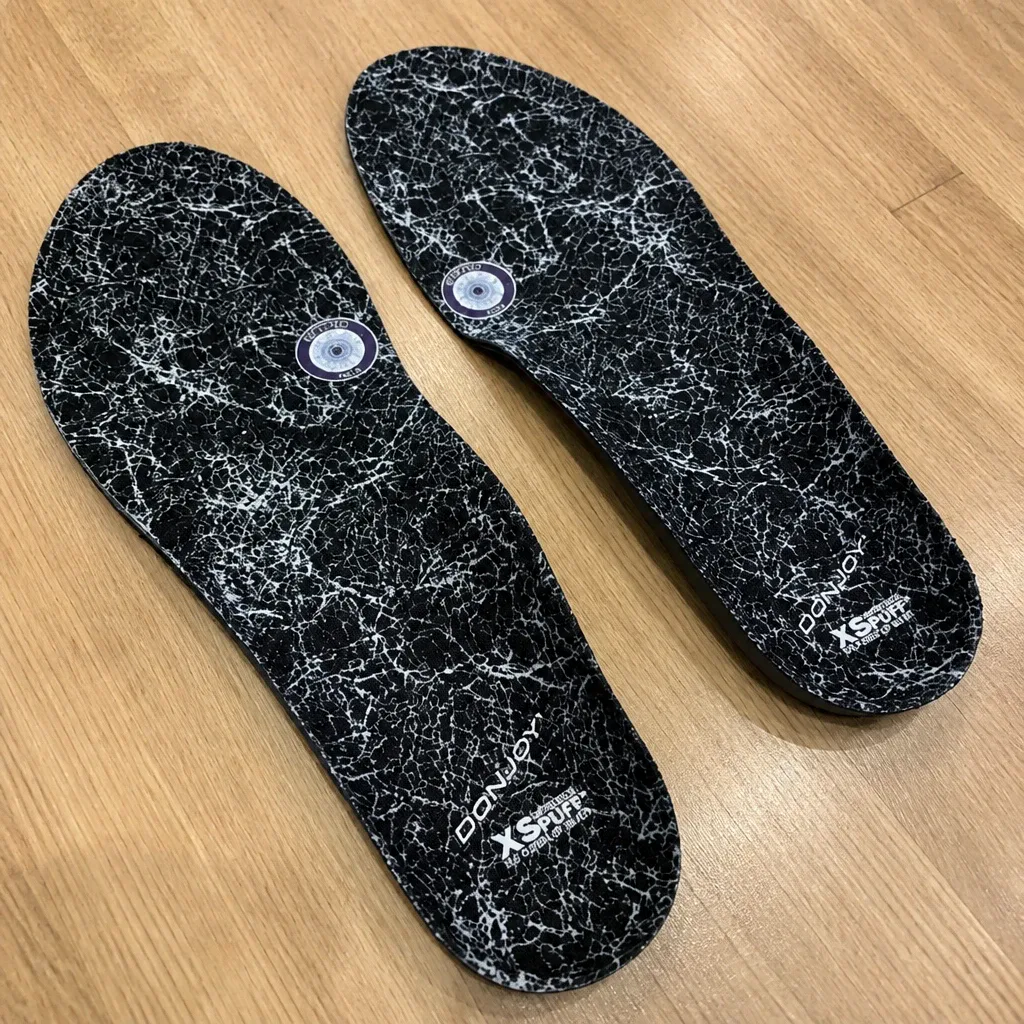 DonJoy insole next to a shoe on a kitchen table during trimming and fit-check