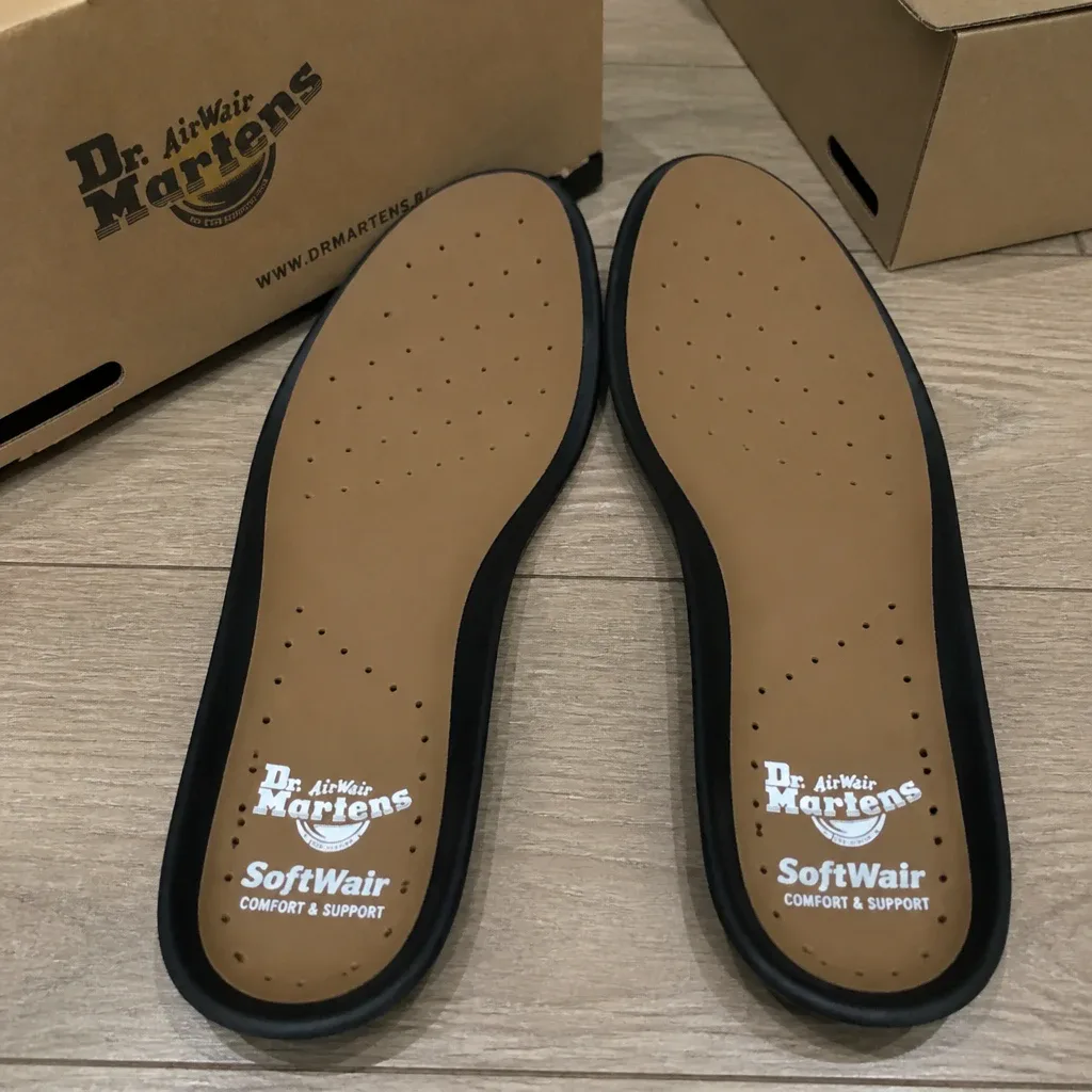Dr. Martens Softwair insole boxes on the floor next to the insoles