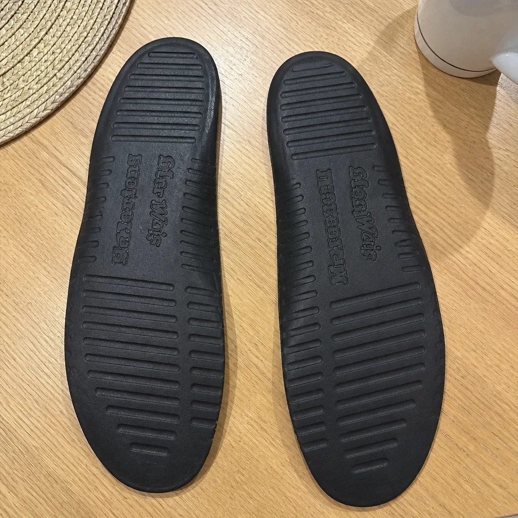 Dr. Martens Softwair insoles airing out on a kitchen table