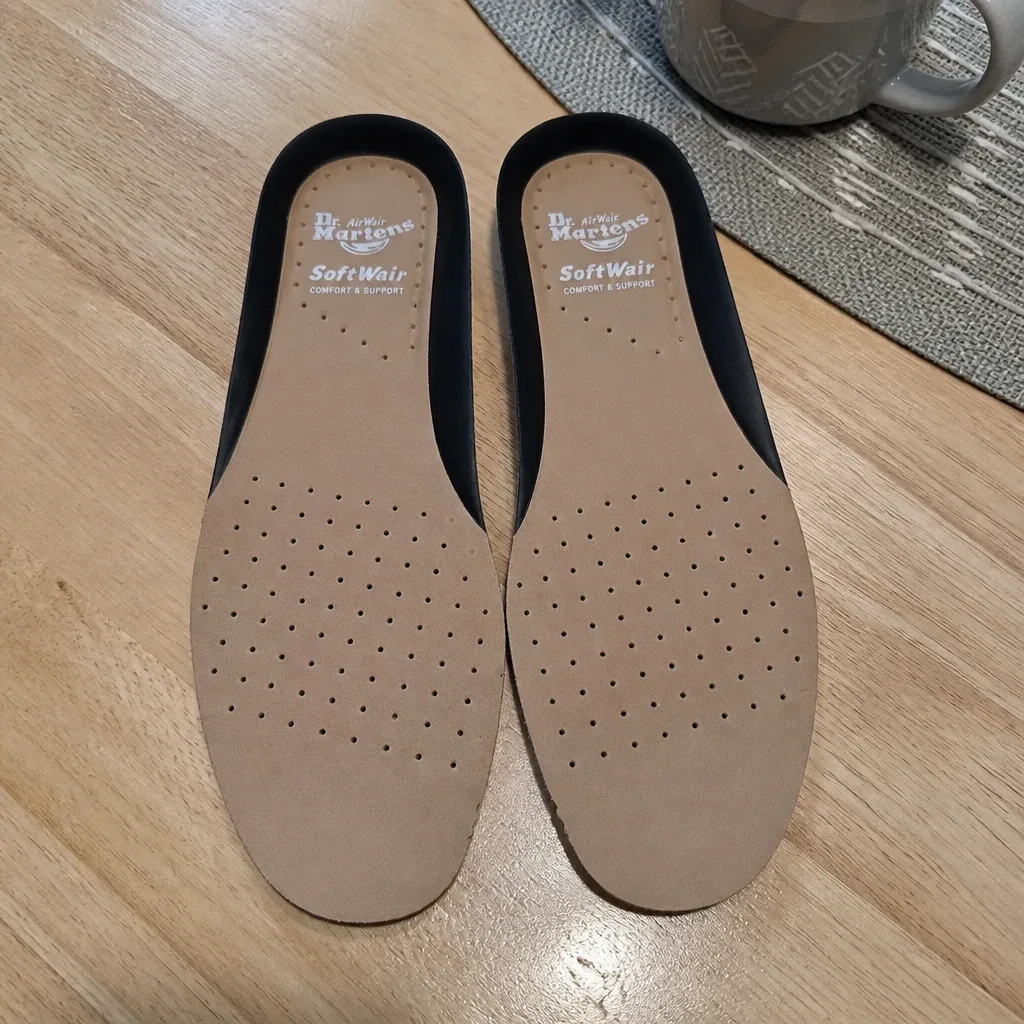 Dr. Martens Softwair insoles laid flat on a kitchen table for measurement