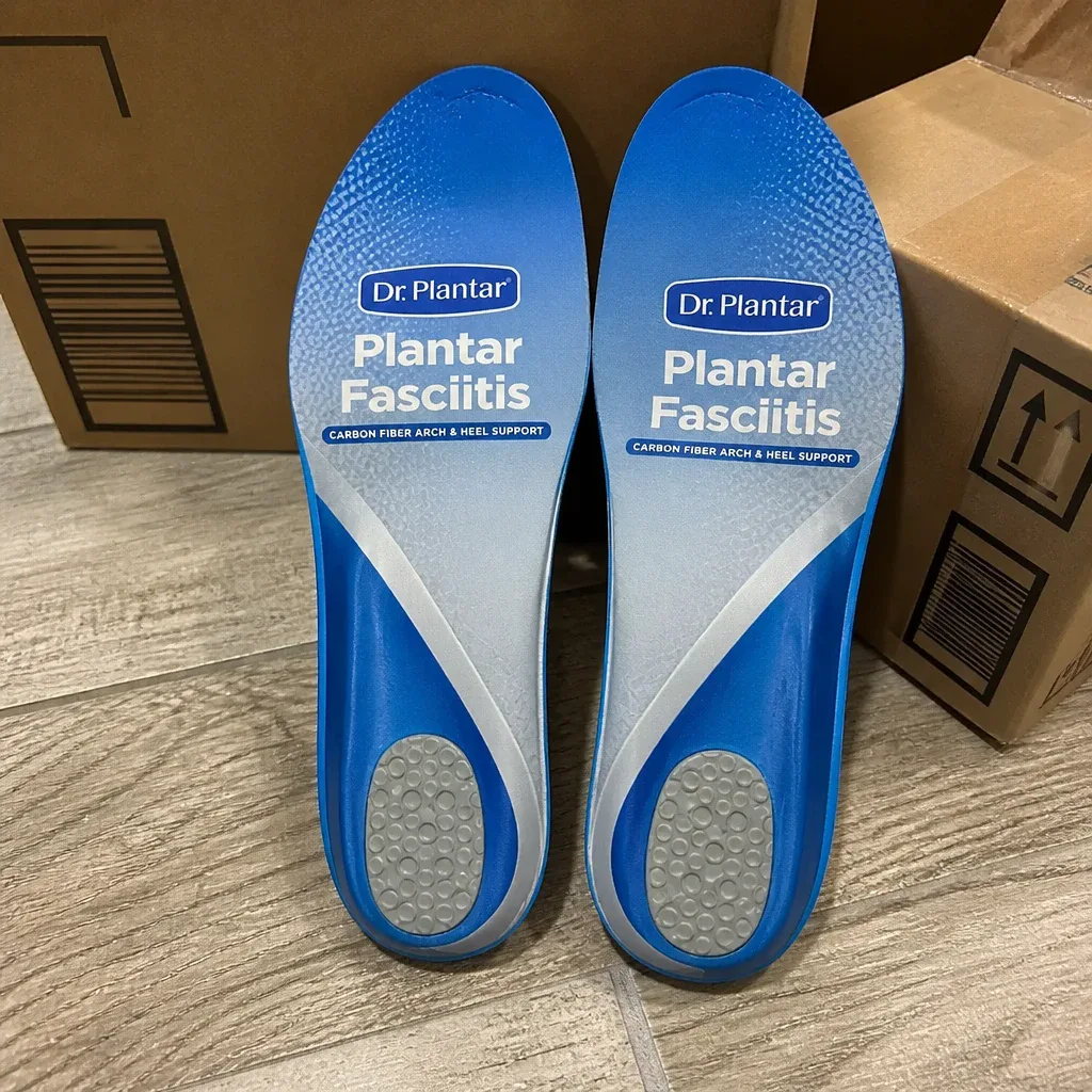 Dr Plantar insole boxes on the floor next to the insoles