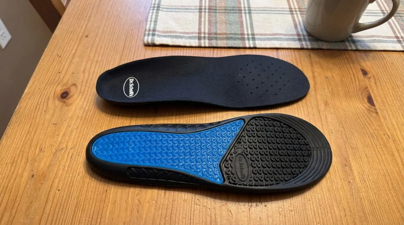 A pair of Dr. Scholl's Work All-Day insoles on a table, top and gel sole sides shown