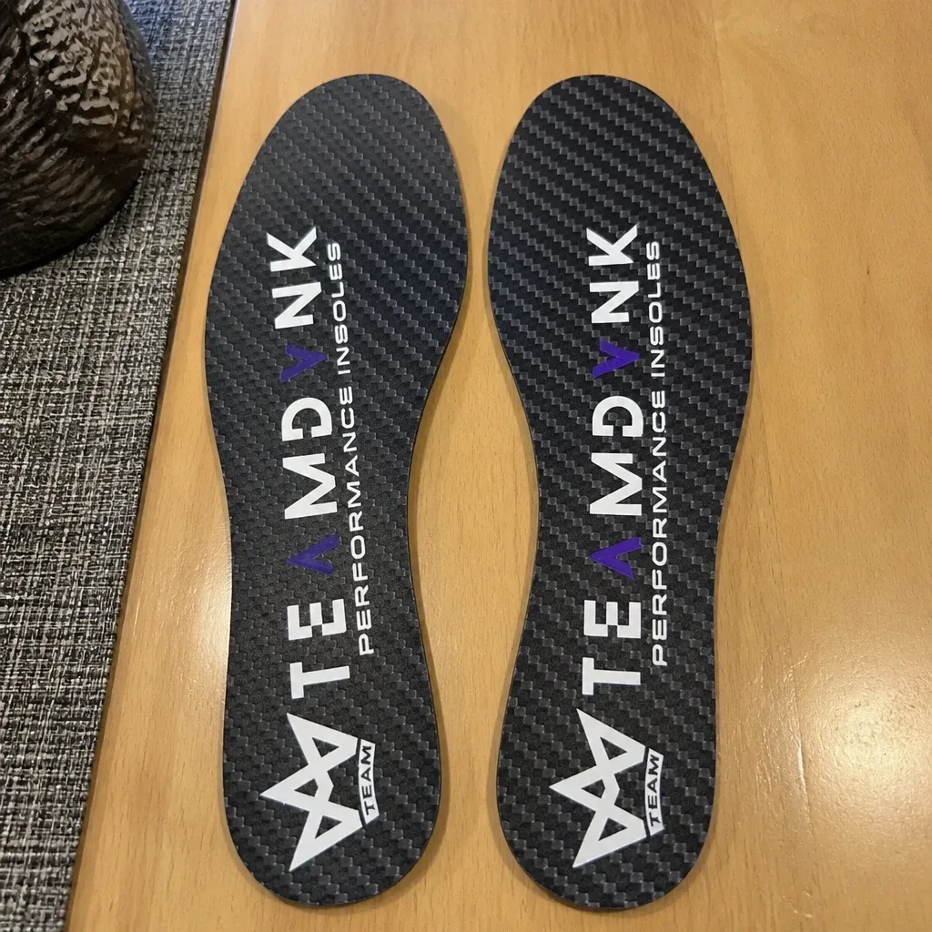 DVNK carbon fiber insoles laid out on a kitchen table after testing