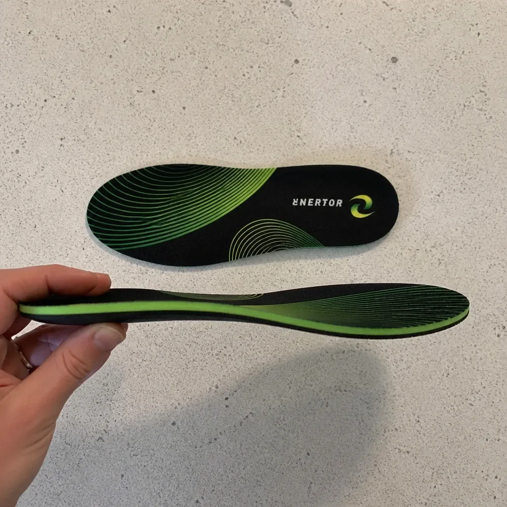 An Enertor PX1 Running Insole held sideways showing the heel-to-toe profile