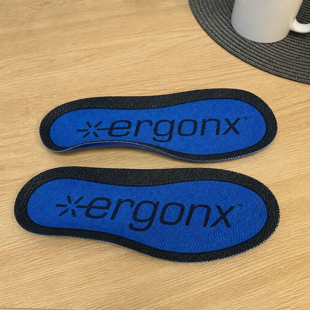 A pair of Ergonx Ultra Soft insoles laid out on a kitchen table