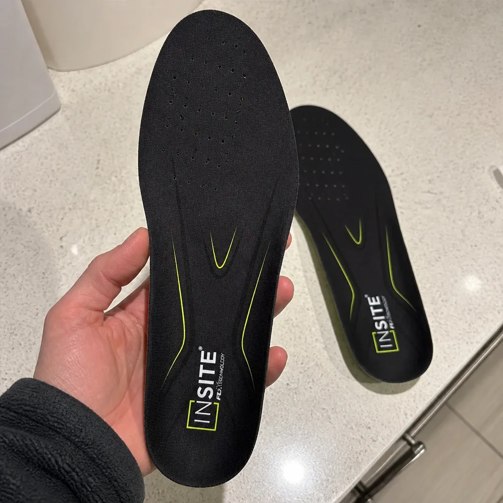 FCX Global Insite Fusion Elite insole held in hand showing the heel cup and arch shape