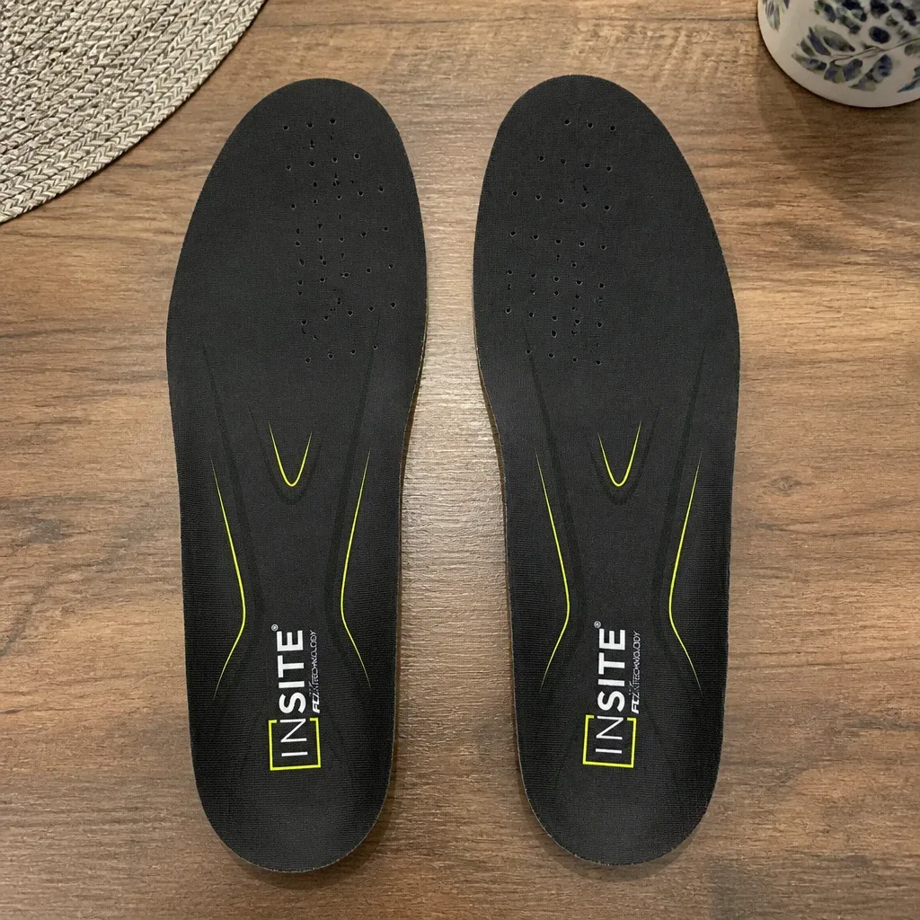 FCX Global Insite Fusion Elite insoles on a kitchen table showing the Black/Yellow colorway and stitching