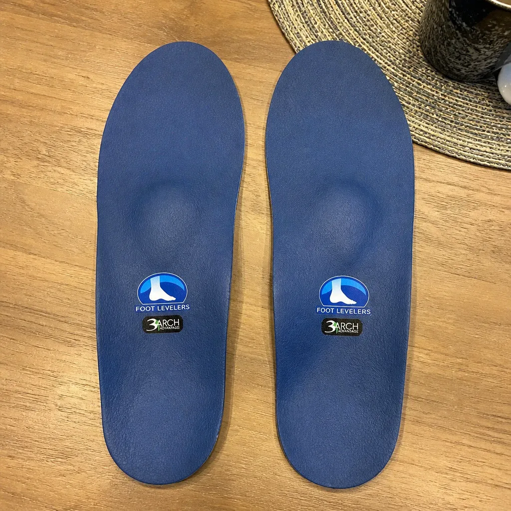 Foot Levelers Elite Comfort custom orthotic pair on a kitchen table
