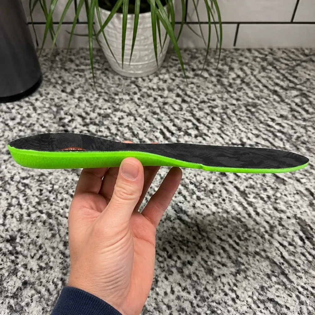 An FP Gamechangers Elite insole held sideways to show its profile