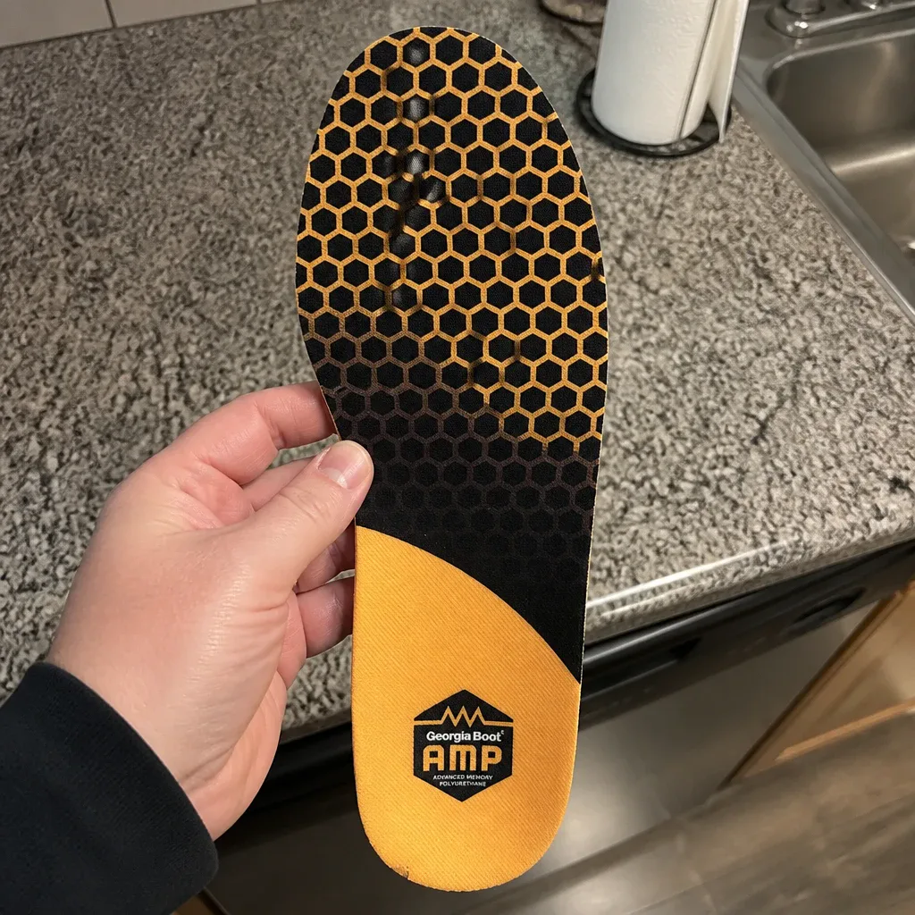 Georgia Boot AMP Insole held in hand showing the memory foam top layer