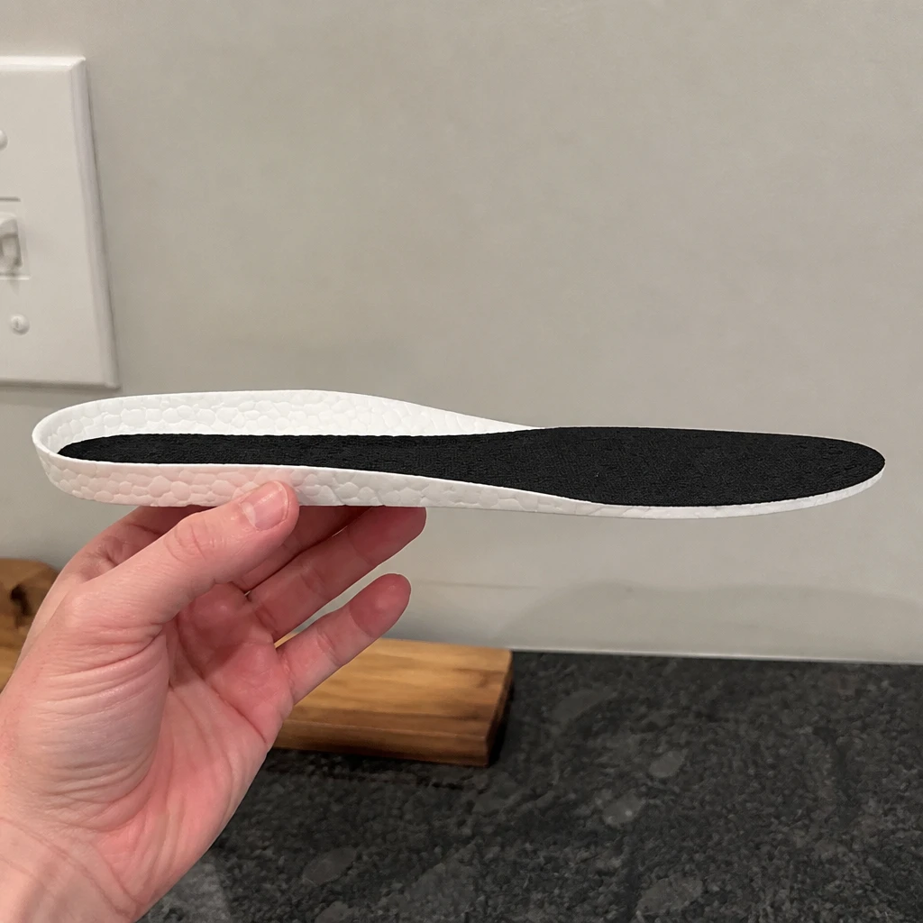 Hefe Luxx Ultra Deluxe 2.0 insole held sideways to show heel thickness