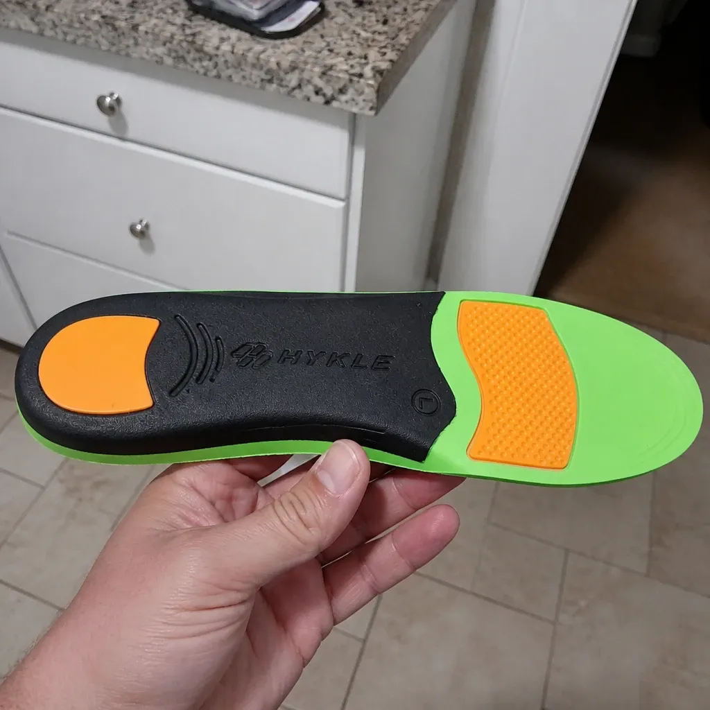 The underside of a HYKLE Impact Pro insole with the orange heel and forefoot pads