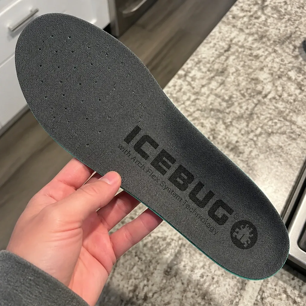Icebug Comfort insole held in hand showing the molded arch shelf