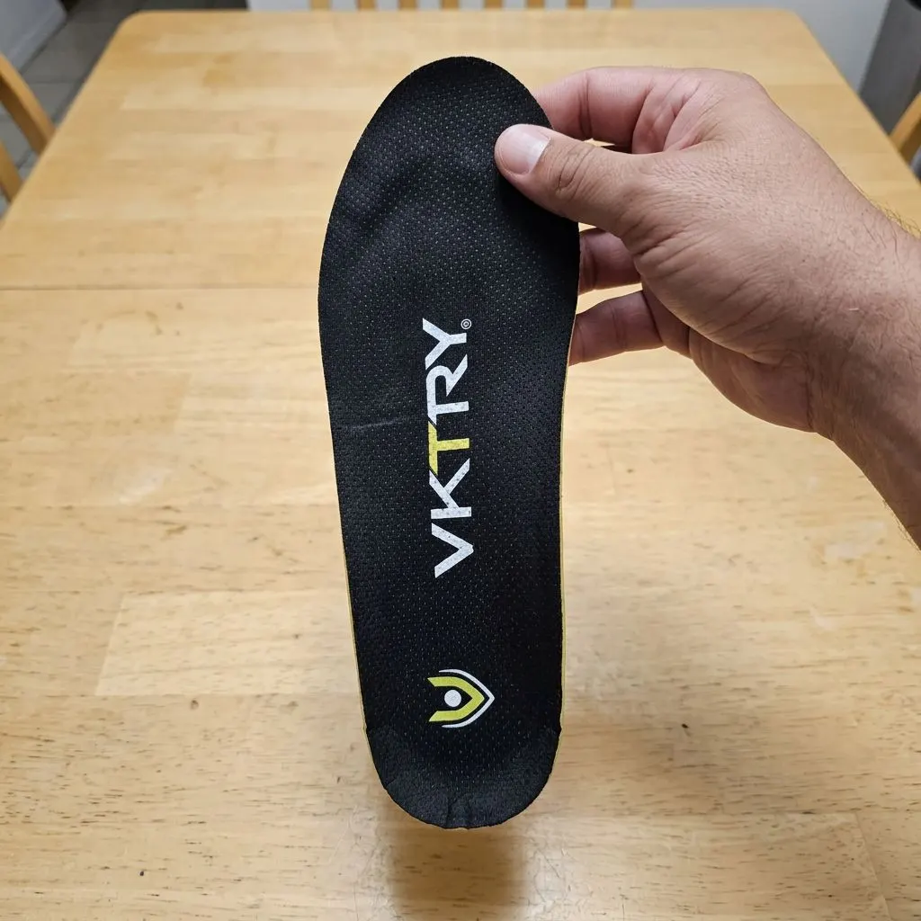 VKTRY Gold insole held in hand, showing the branded top cover and logo
