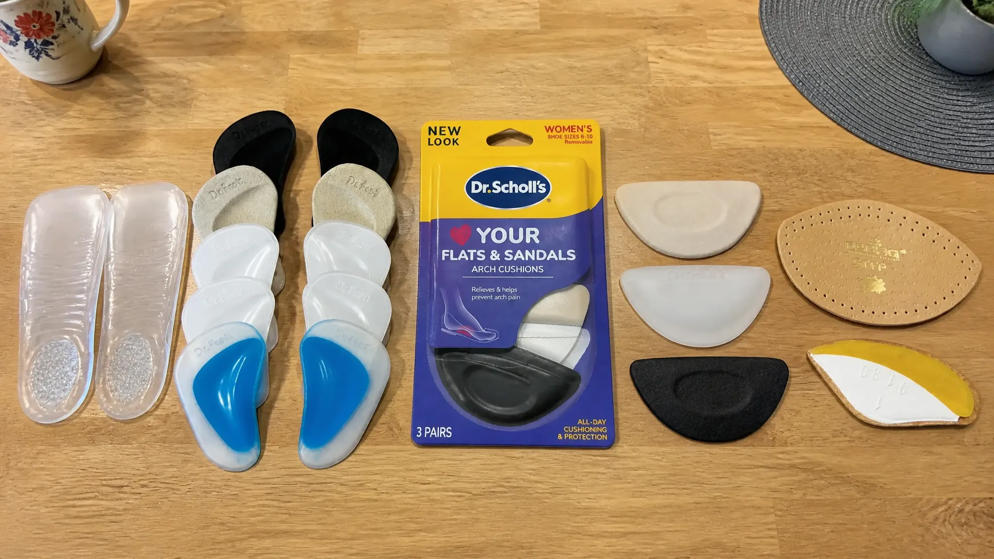 Real arch support inserts tested for sandals, lined up side by side, including Dr. Scholl's, Dr.Foot, pedag, and VIVEsole